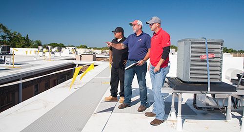 Click image of roofers on Florida Commercial Roof to open Commercial Roof Replacement Services page.