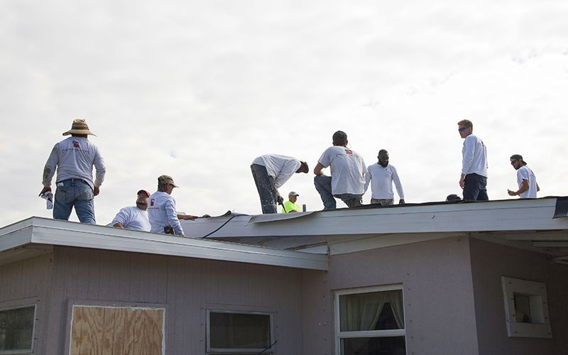 A team of Florida Southern Roofing roofers working on Mr. Bostic's roof.
